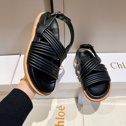 CROSS STRAP SANDAL IN BLACK RUBBER WITH GOLD HARDWARE