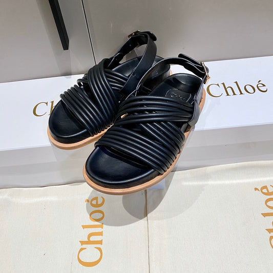 CROSS STRAP SANDAL IN BLACK RUBBER WITH GOLD HARDWARE