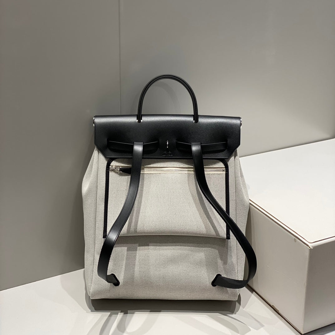 HERBAG A DOS ZIP RETOURNE BACKPACK 29 IN OFF-WHITE CANVAS AND BLACK CALFSKIN
