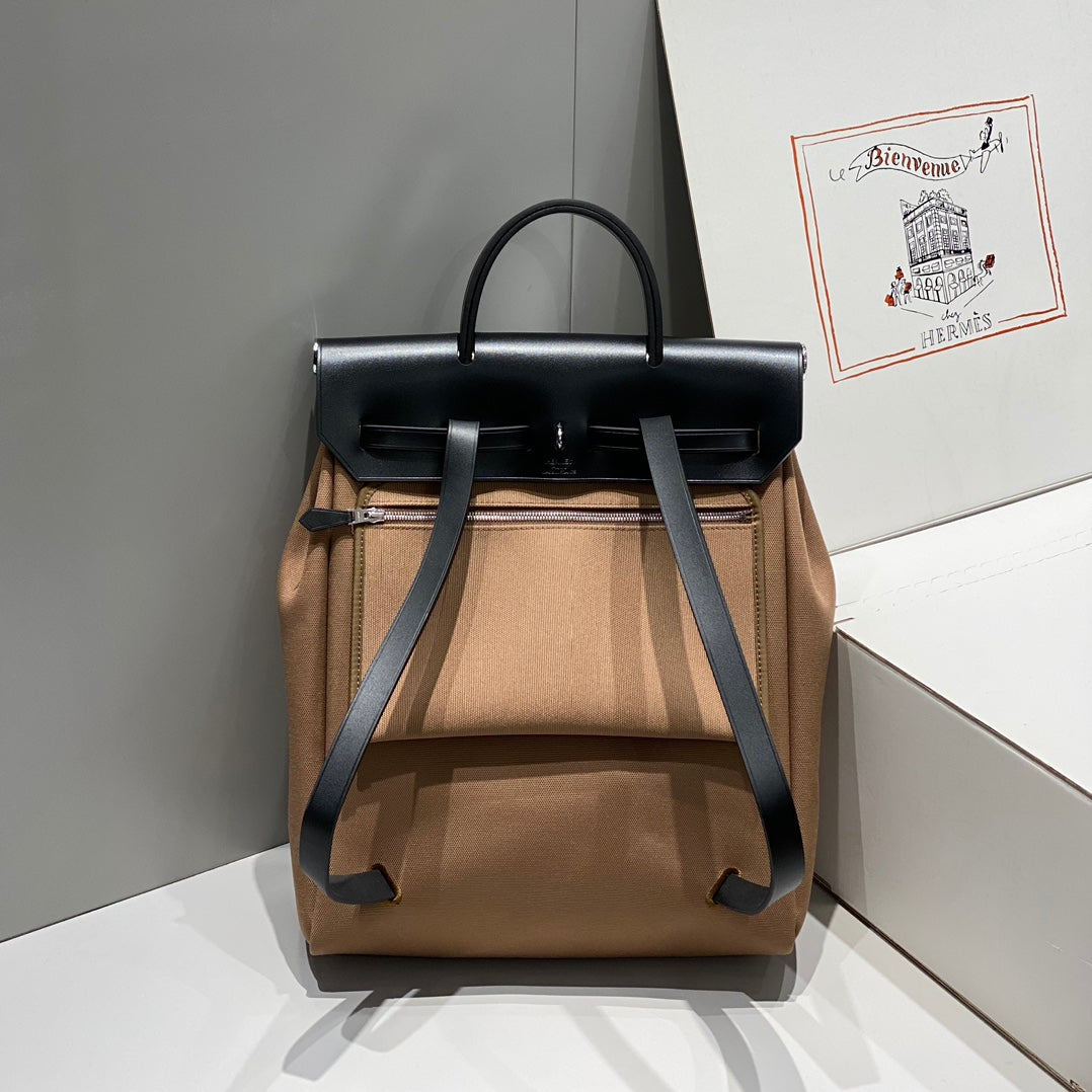 HERBAG A DOS ZIP RETOURNE BACKPACK 29 IN BROWN CANVAS AND BLACK CALFSKIN