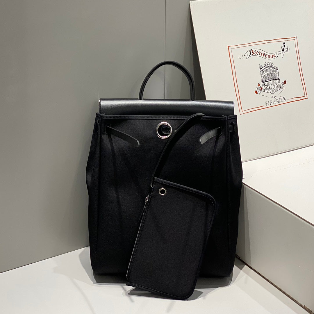 HERBAG A DOS ZIP RETOURNE BACKPACK 29 IN BLACK CANVAS AND CALFSKIN