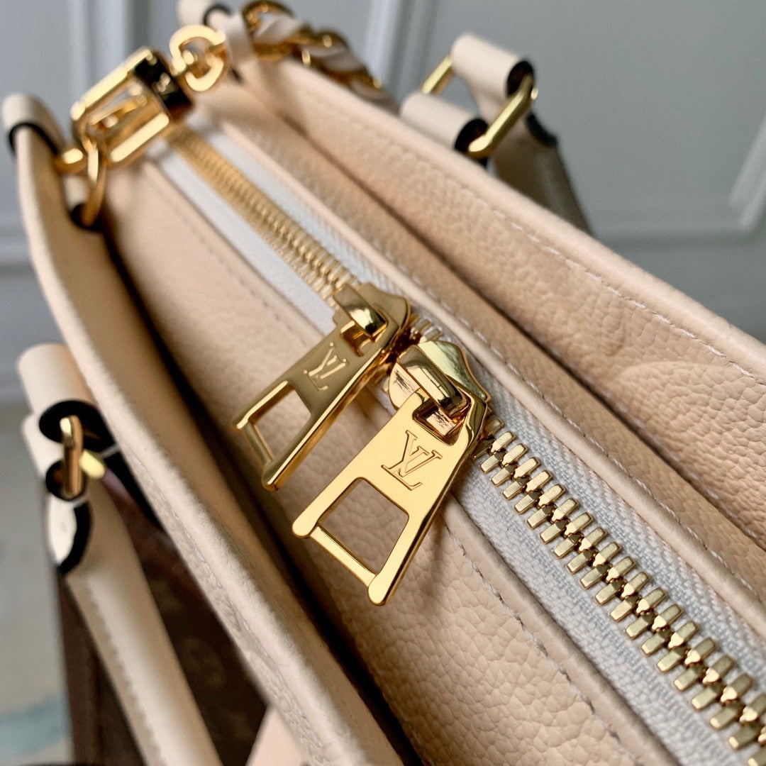 ONTHEGO EAST WEST BAG 25 IN BEIGE MONOGRAM EMBOSSED COWHIDE