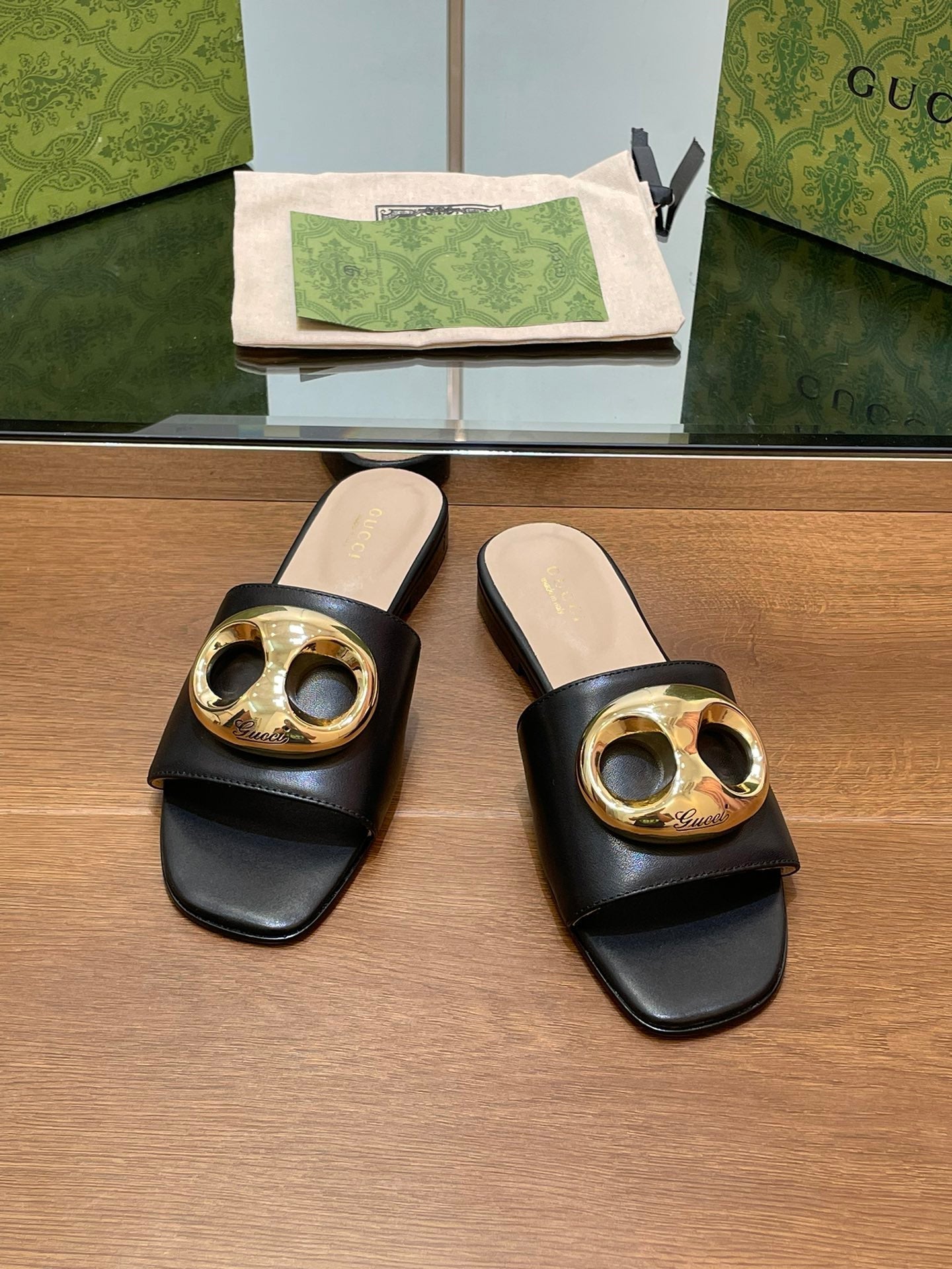 FLAT MULE IN BLACK CALFSKIN WITH GOLD HARDWARE